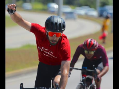American Andy Scarano celebrates after winning the third and final stage of the Jamaica Montego Bay International Cycling Classic yesterday.