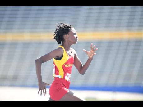 ISSA/GraceKennedy Boys and Girls' Athletics Championships 100-metre champion, Wolmer's Girls' Natrece East on her way to winning heat one of the 200 inside the National Stadium earlier this morning.