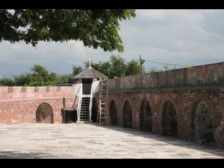 
A view of the walls guarding Fort Charles converging in a watch tower.