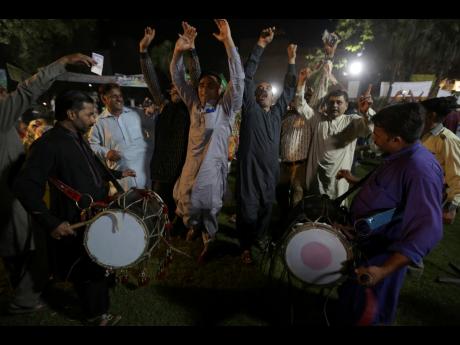Supporters of newly elected Pakistani Prime Minister Shahbaz Sharif dance to celebrate outside their party’s office in Lahore, Pakistan, yesterday.
