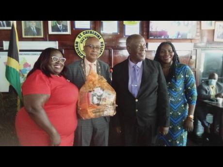 From left: Councillor Keisha Lewis, Spanish Town Mayor Norman Scott, Deputy Mayor Ralston Wilson and Councillor Pat Harris pause to capture the moment after both men were presented with awards for serving in their respective capacities for a decade.