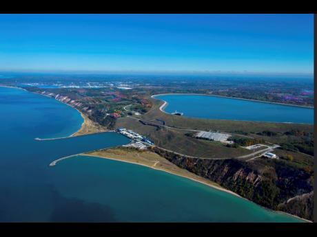 Credit: AP This undated photo provided by Consumers Energy shows an aerial view of the Ludington Pumped Storage Plant near Ludington, Michigan, which generates electricity by pumping water from Lake Michigan to a reservoir on top of a bluff, then releasing it through