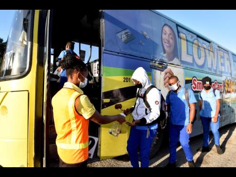 Credit: File Passengers prepare to board a JUTC bus.