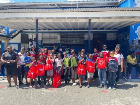 Student Services and Development Manager and Resident Advisors from the Elsa Leo-Rhynie Hall, UWI with students from the Morant Bay Primary School who were gifted during the outreach project on April 2.