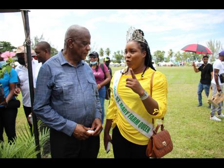 Minister of State in the Ministry of Agriculture and Fisheries, Franklin Witter in discussion with the St Mary Farm Queen.