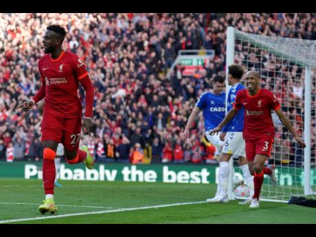 Credit: AP Liverpool’s Divock Origi (left) celebrates after scoring his side’s second goal during the English Premier League match between Liverpool and Everton at Anfield stadium in Liverpool, England yesterday.