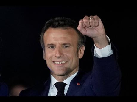 French President Emmanuel Macron celebrates with his supporters in Paris, France, on Sunday after winning another five years in the French presidential palace.