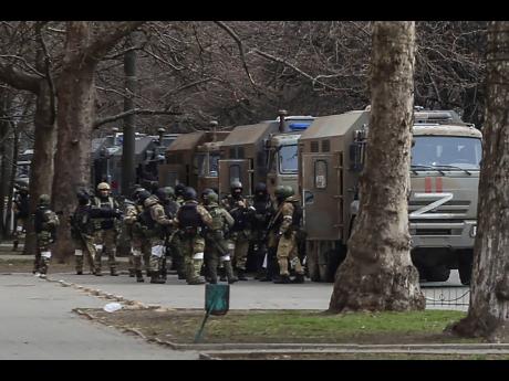Credit: AP AP
Russian army soldiers stand next to their trucks during a rally against Russian occupation in Svobody (Freedom) Square in Kherson, Ukraine, on March 7.