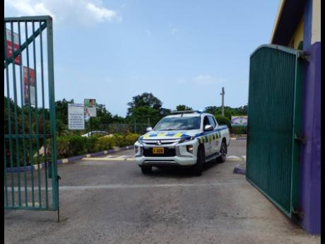 Credit: Photo by Hopeton Bucknor A police service vehicle exits the Hopewell High School compound in Hanover yesterday after responding to reports of a bloody fight between two groups of male students at the institution. Classes were suspended for the day.