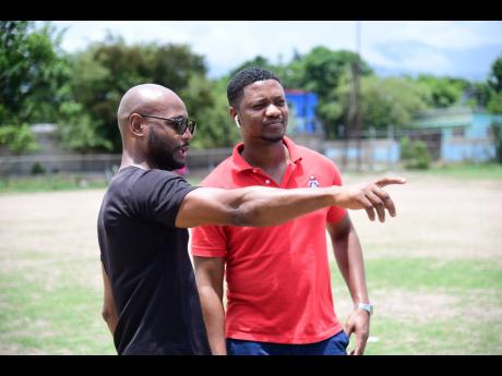 Credit: Gladstone Taylor Boxing coach Sakima Mullings (left) and Christopher Jackson (Student, University of the West Indies Faculty of Sport) in dialogue as renovations were taking place at the Suga Knockout Boxing Gym at The Olympic Gardens Football Club yesterday.