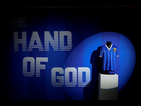 
The Argentina football shirt worn by Diego Maradona in the 1986 Mexico World Cup quarterfinal soccer match between Argentina and England, is displayed at Sotheby’s auction house, in London, Wednesday, April 20, 2022. 