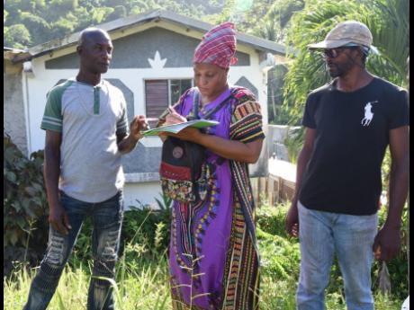 Annette Aarons (centre), mother of Lomorra Dillon, solicits support for her daughter whose challenge to the sitting colonel of the Moore Town Maroons, Wallace Sterling, was aborted on Sunday.