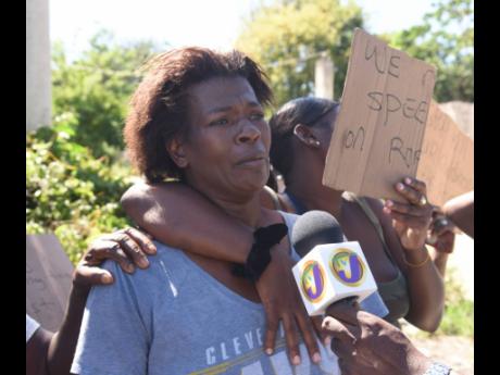 Credit: Ashley Anguin/Photographer Sandra McIntosh-Bryan, mother of 11-year-old Jason Bryan, breaks down during an interview in Gutters,
St James, on Tuesday. Jason died from crash injuries on Monday.
