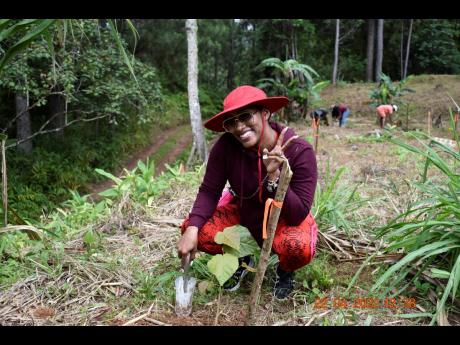 Tanaania is all smiles after planting a Blue Mahoe seedling.