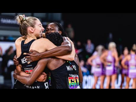Sunshine Girl and Collingwood Magpies goal shooter, Shimona Nelson (right), is hugged by teammates, another Sunshine Girl Jodi-Ann Ward (centre), and Jacqui Newton after their team’s 71-67 Suncorp Super Netball League win over the Queensland Firebirds in
