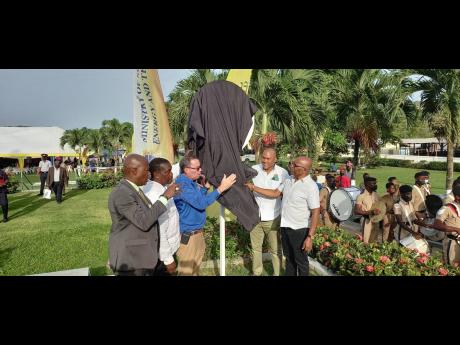 St Mary Central Member of Parliament Dr Morais Guy (right) and Port Maria Mayor Richard Creary participate in the unveiling of a Wi-Fi hotspot for the St Mary capital on Thursday. Also taking part are (from left) Universal Service Fund CEO Daniel Dawes, St
