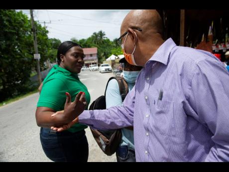 St Catherine North East Member of Parliament Kerensia Morrison pulls away despite entreaties by Spanish Town Mayor Norman Scott for a hug on Monday. Morrison was peeved at being kept in the dark about a facelift to the Natural Bridge – a parish Labour Da