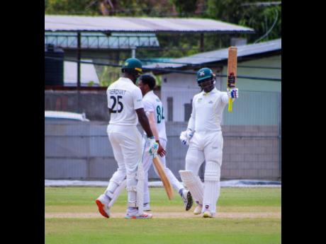 Credit: Brandon Corlette Jamaica Scorpions wicket-keeper batsman Aldane Thomas raises his bat and acknowledges the applause from teammates after scoring a century against the Guyana Harpy Eagles.