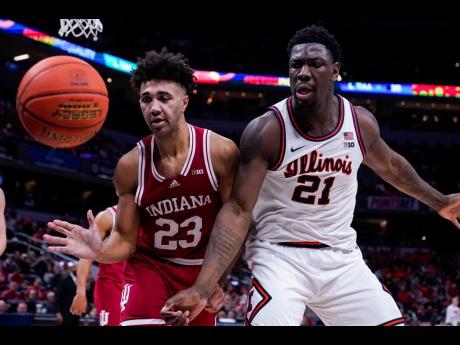 Indiana forward Trayce Jackson-Davis (23) and Illinois centre Kofi Cockburn eye a loose ball in the first half of a NCAA college basketball game at the Big Ten Conference tournament in Indianapolis on Friday, March 11. 