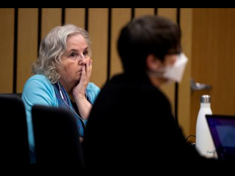Romance writer Nancy Crampton Brophy (left), accused of killing her husband, Dan Brophy, in June 2018, watches proceedings in court in Portland, Oregon, Monday, April 4, 2022.