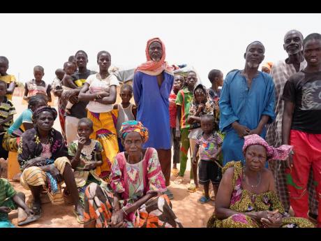 Internally displaced people wait for aid in Djibo, Burkina Faso on Thursday. 