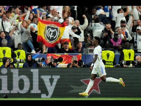 Real Madrid's Vinicius Junior celebrates after scoring the opening goal during the Champions League final soccer match between Liverpool and Real Madrid at the Stade de France in Saint Denis near Paris on Saturday.