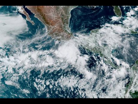 This satellite image made available by NOAA shows Hurricane Agatha (centre) off the Pacific coast of Mexico on Sunday.