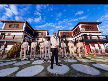 The groom is backed by an army of groomsmen, uniformly attired for the grand occasion. 