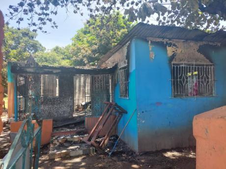 The burnt-out three-bedroom house at 12 Balmagie Avenue in Olympic Gardens, St Andrew, which is suspected to have been set ablaze by arsonists on Wednesday morning.