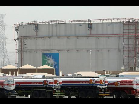 
Fuel trucks line up in front of storage tanks at the North Jiddah bulk plant, an Aramco oil facility, in Jiddah, Saudi Arabia, on March 21, 2021.