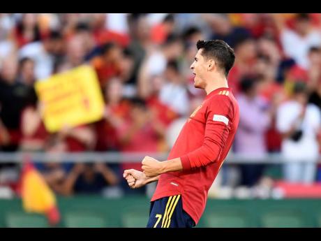 Spain’s Alvaro Morata celebrates after scoring the opening goal during the UEFA Nations League match between Spain and Portugal, at the Benito Villamarin Stadium, in Seville, Spain yesterday. 
