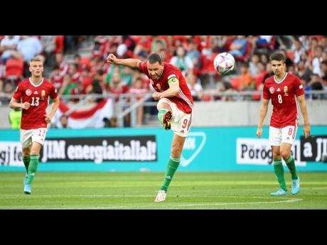 
Hungary’s Adam Szalai (centre) shoots during the UEFA Nations League football match between Hungary and England at the Puskas Arena in Budapest, Hungary, yesterday.