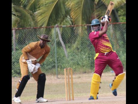  St Catherine Cricket Association  opener Adrian Bartley plays a shot on his way to a top score of 51 as GC Foster wicket-keeper Aaron Daley Jnr looks on during their Jamaica Cricket Association All-Island 50-over encounter at Port Esquivel  on Saturday.