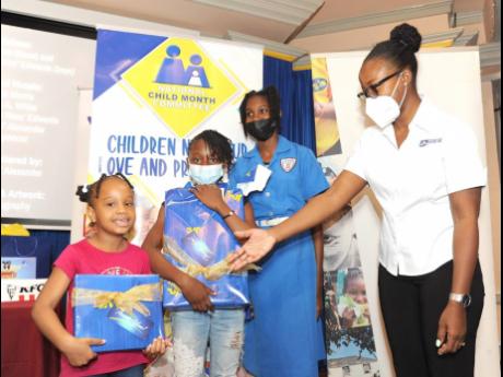 Shanna Kaye Wright Vaughn (right), Lead – Youth and Education Programmes, JN Foundation, congratulates winners of the National Child Committee Competition on the theme ‘Listen Up! Children’s Voices Matter’. The presentation was made to the children