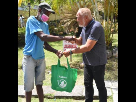 Raymond Brown (left) receives his care package from Apostle Dr Richard Keane, pastor of Family Church on the Rock. 