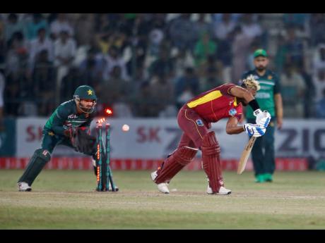 West Indies’ Nicholas Pooran (centre) is bowled by Pakistan’s Mohammad Nawaz during the second one-day international cricket match between Pakistan and West Indies at the Multan Cricket Stadium, in Multan, Pakistan yesterday.