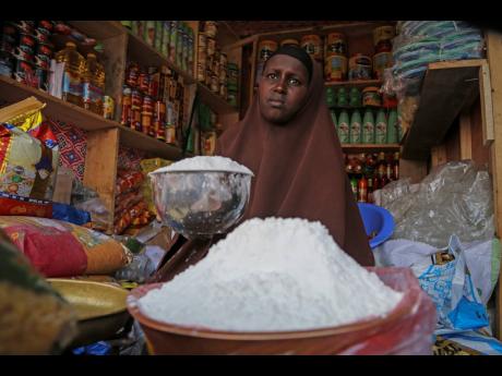 
A shopkeeper sells wheat flour in the Hamar-Weyne market in the capital Mogadishu, Somalia. The United Nations is warning that the price hikes are coming as many parts of Africa are facing drought and hunger. 