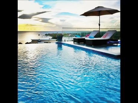 The infinity pool, sea and the horizon are at one with each other.