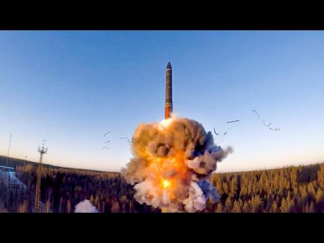 In this file photo taken from a video distributed by Russian Defence Ministry Press Service on Wednesday, December 9, 2020, a rocket launches from a missile system as part of a ground-based intercontinental ballistic missile test launched from the Plesetsk