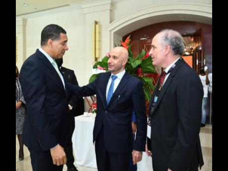 Prime Minister Andrew Holness (left) speaks with Dr Mohammed Al Zarooni, chairman of the World Free Zones Organization; and Dr Samir Harouni, CEO of the World Free Zones Organization, at the eighth annual International Conference and Exhibition (AICE 2022)