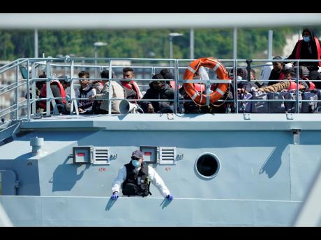 A group of people thought to be migrants are brought in to Dover by Border Force, following a small boat incident in the Channel, in Kent, England, yesterday.
