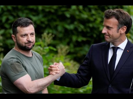 Ukraine President Volodymyr Zelenskyy (left), and France’s President Emmanuel Macron shake hands at the end of a press conference at the Mariyinsky Palace in Kyiv, Ukraine yesterday.