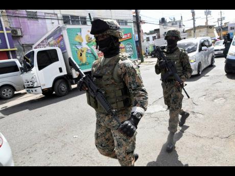 Credit: Rudolph Brown
Heavily armed police and military personnel patrol in Spanish Town following ongoing gang conflict. Shocking was the brazenness of the daylight duel that totally disregarded the collateral damage that could occur from the warfare eruption.