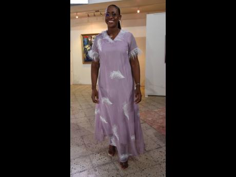 Credit: Ian Allen Juliet Holness cut quite a fine figure in a lilac dress with feather embellishments and clear sandals.