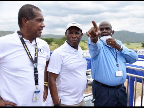 Lyttleton ‘Tanny’ Shirley (left), chairman of the Factories Corporation of Jamaica, and Senator Aubyn Hill (centre), minister of industry, investment and commerce, listen as Gary Lawrence, vice-president of engineering at the Port Authority of Jamaica,