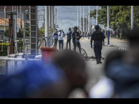Rwandan border security forces stand guard on their side of the Petite Barriere border crossing with Rwanda in Goma, eastern Congo, on Friday. 