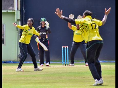 Jamaica’s Vanessa Watts (left) appeals successfully for the wicket of Guyana’s Cherry Ann Fraser during their Super 50 semi final at Providence Stadium in Guyana yesterday. 