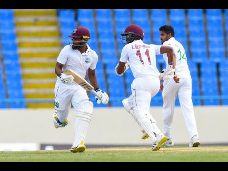 File
West Indies openers John Campbell (left) and Kraigg Brathwaite cross for a  quick single.