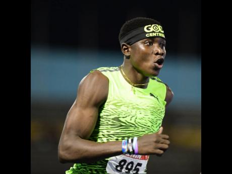 Sandrey Davison celebrates winning the Under-20 Boys' 100 metres at the JAAA National Senior and Junior Athletics Championships inside the National Stadium this evening.