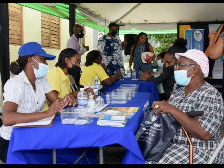 Credit: Ashley Anguin/Photographer Ronique Robinson (left) of the Ministry of Labour and Social Security speaks with Ethma Doeman (right) during the launch of the Ministry of Labour and Social Security’s community engagement series for the Programme of Advancement Through Health and Educa